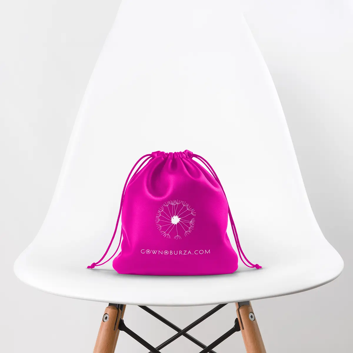 Pink drawstring bag on a white chair